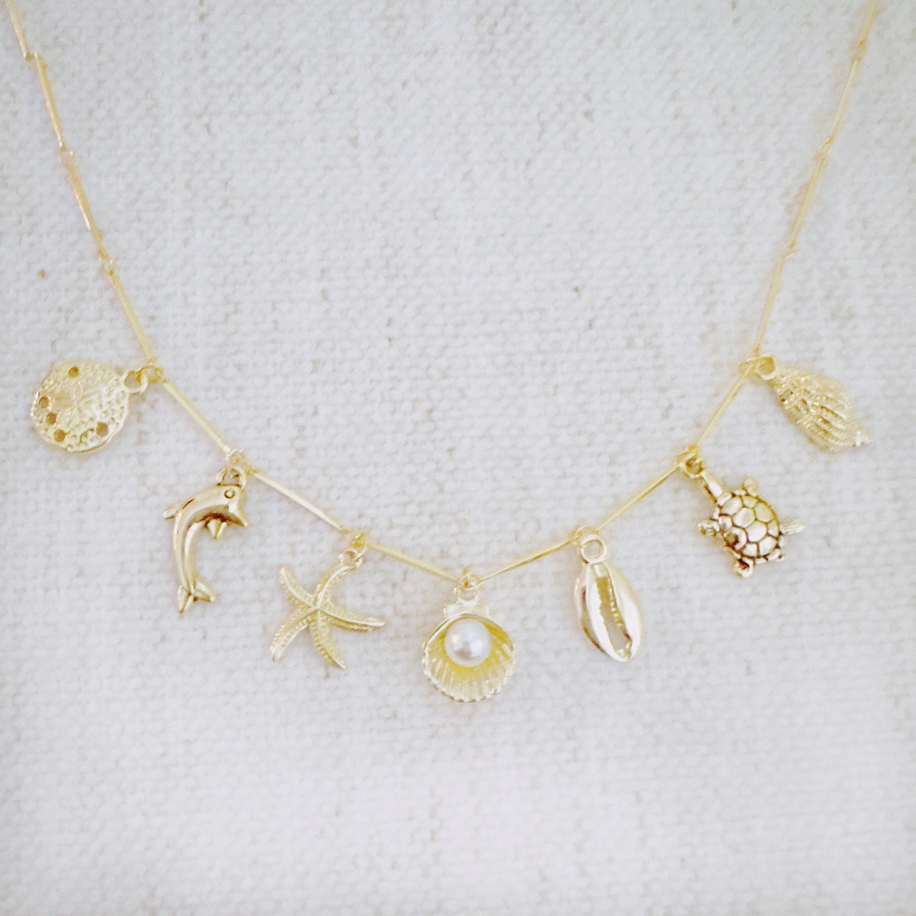 Golden Sea Charm Necklace – Shell, Dolphin & Starfish